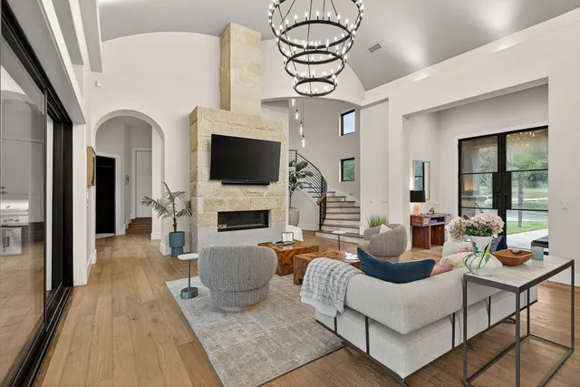 a living room with fireplace furniture and a flat screen tv
