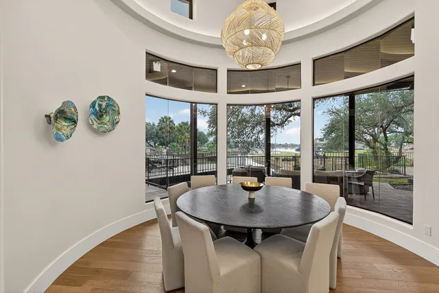 a view of a dining room with furniture a chandelier and wooden floor
