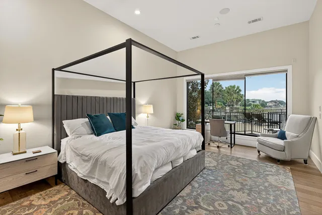 a bedroom with a bed and a large window