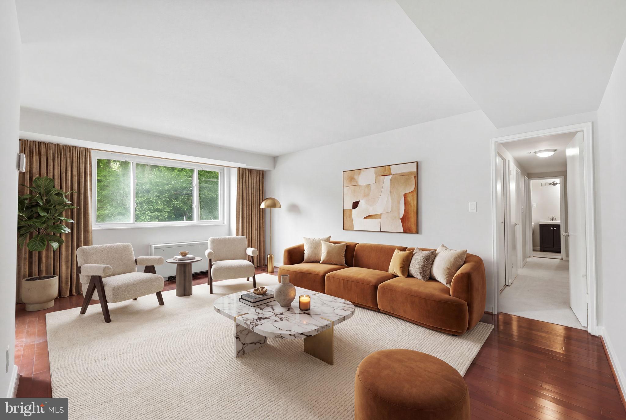 95 East Wayne Avenue, Unit 101 Silver Spring, MD 20901 - Photo 1 of 20 a living room with furniture and a large window