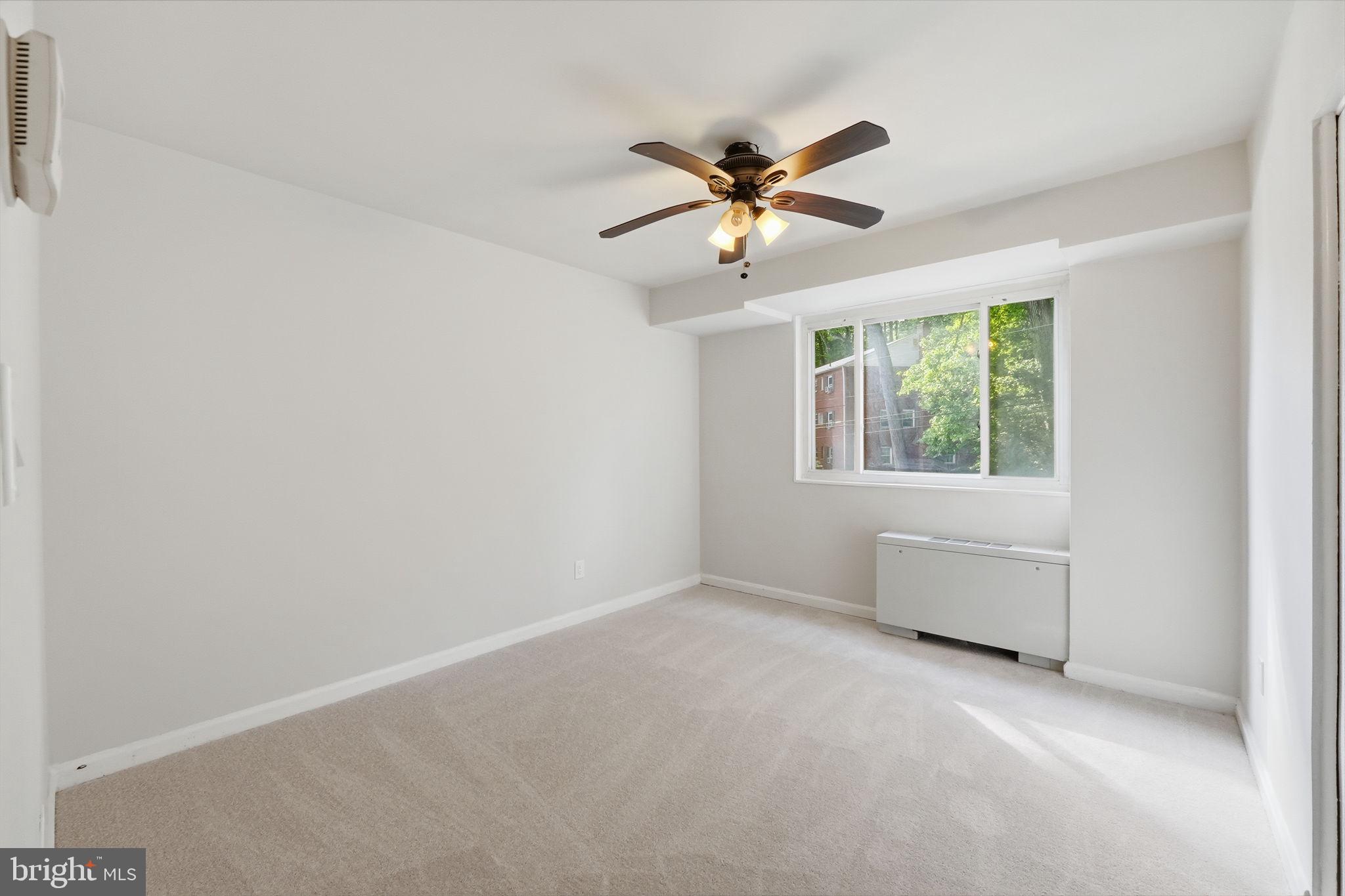 95 East Wayne Avenue, Unit 101 Silver Spring, MD 20901 - Photo 17 of 20 an empty room with windows and fan