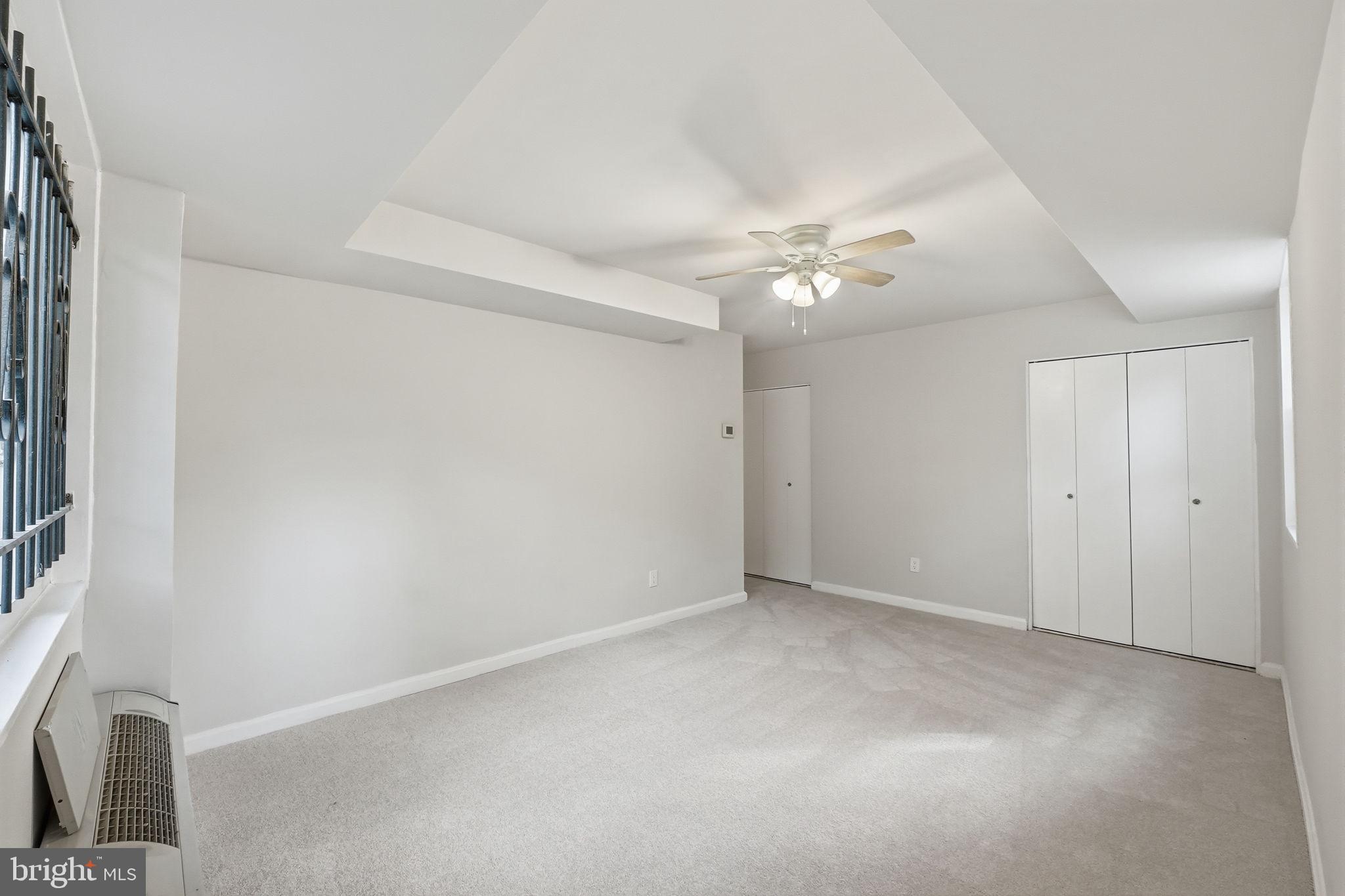 95 East Wayne Avenue, Unit 101 Silver Spring, MD 20901 - Photo 20 of 20 a view of an empty room with a ceiling fan and a window