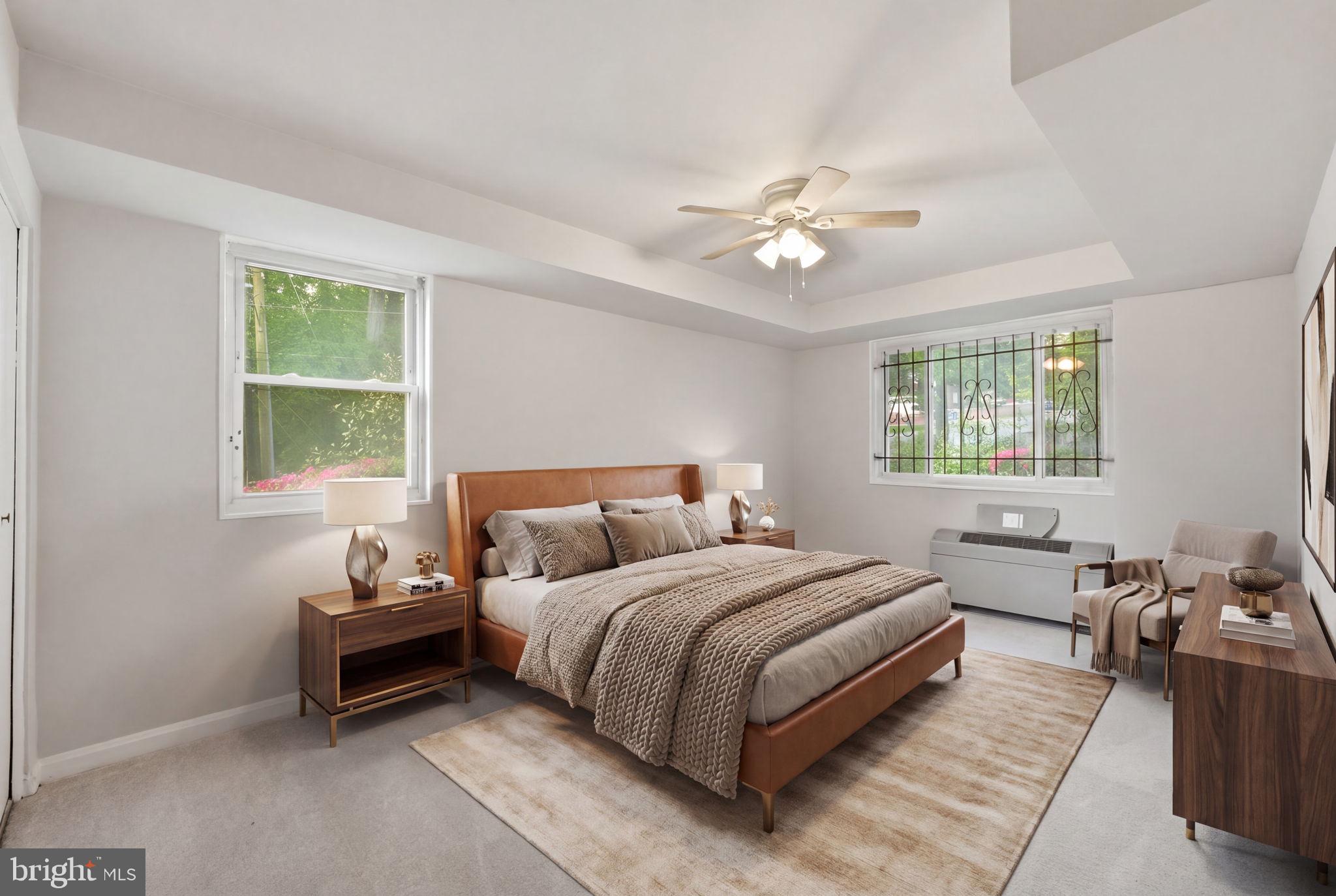 95 East Wayne Avenue, Unit 101 Silver Spring, MD 20901 - Photo 8 of 20 a bedroom with a bed and a couch