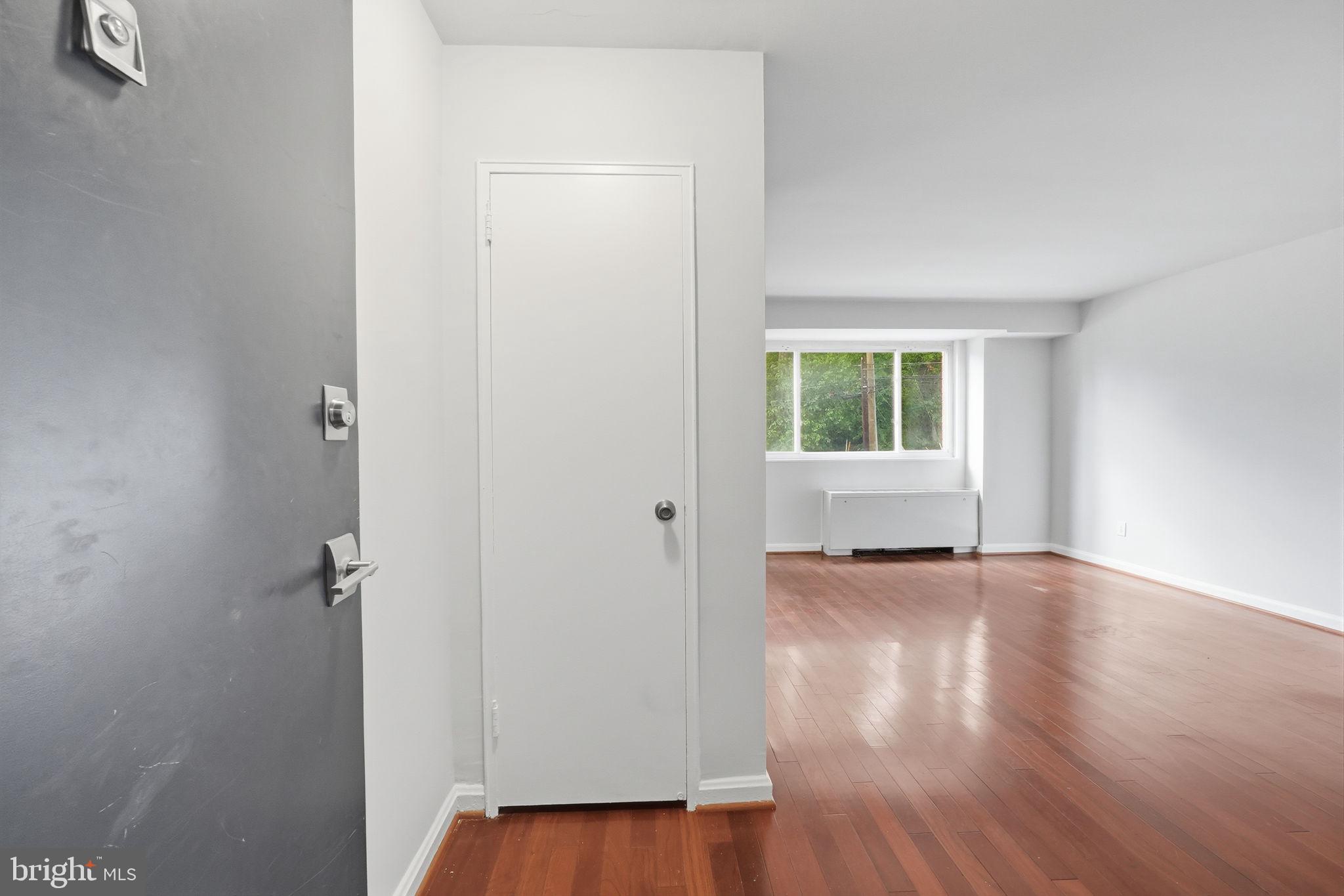 95 East Wayne Avenue, Unit 101 Silver Spring, MD 20901 - Photo 10 of 20 an empty room with wooden floor and a window