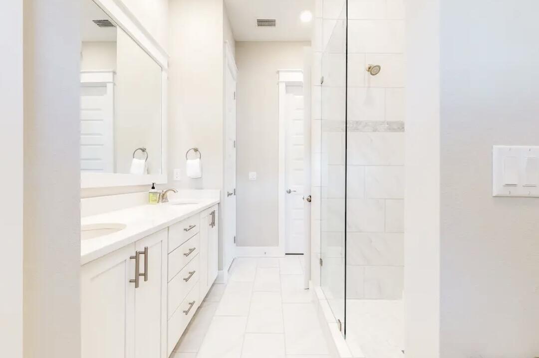 106 York Ln Inlet Beach, Unit A Inlet Beach, FL 32461 - Photo 21 of 28 a bathroom with a double vanity sink and a mirror