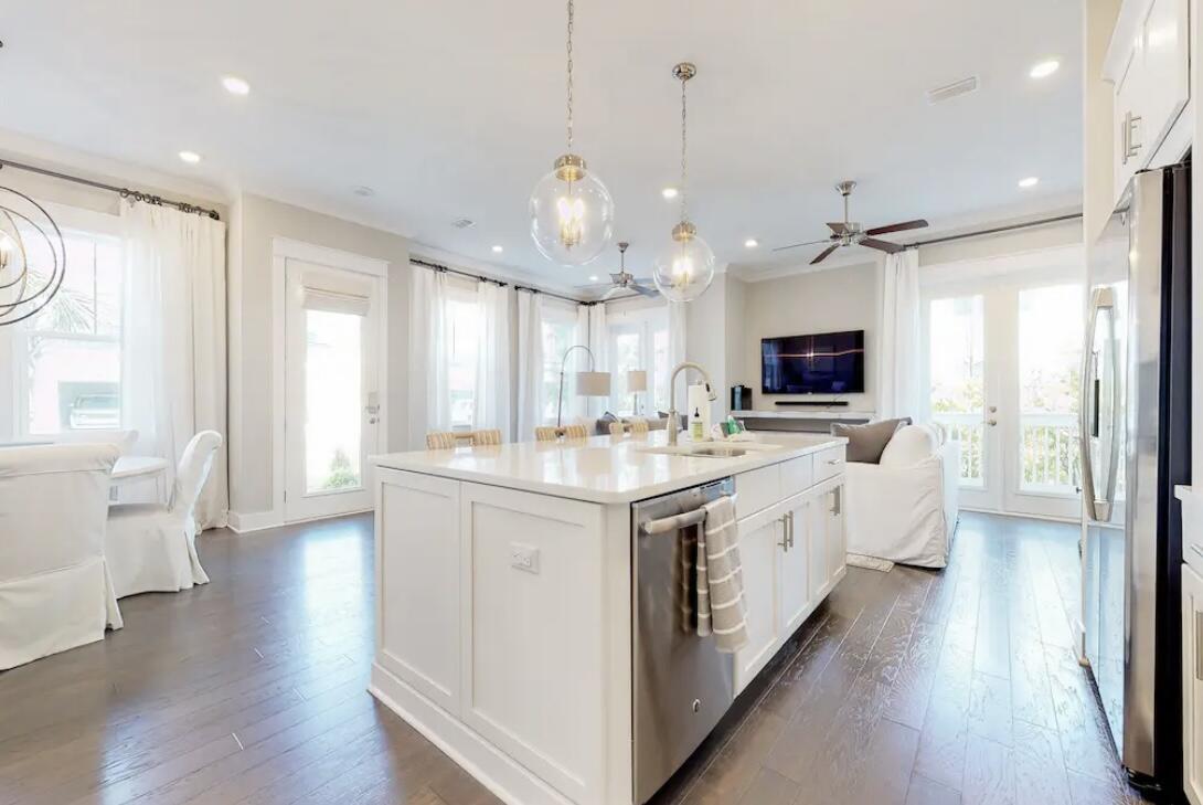 106 York Ln Inlet Beach, Unit A Inlet Beach, FL 32461 - Photo 4 of 28 a large white kitchen with lots of counter space wooden floor and appliances