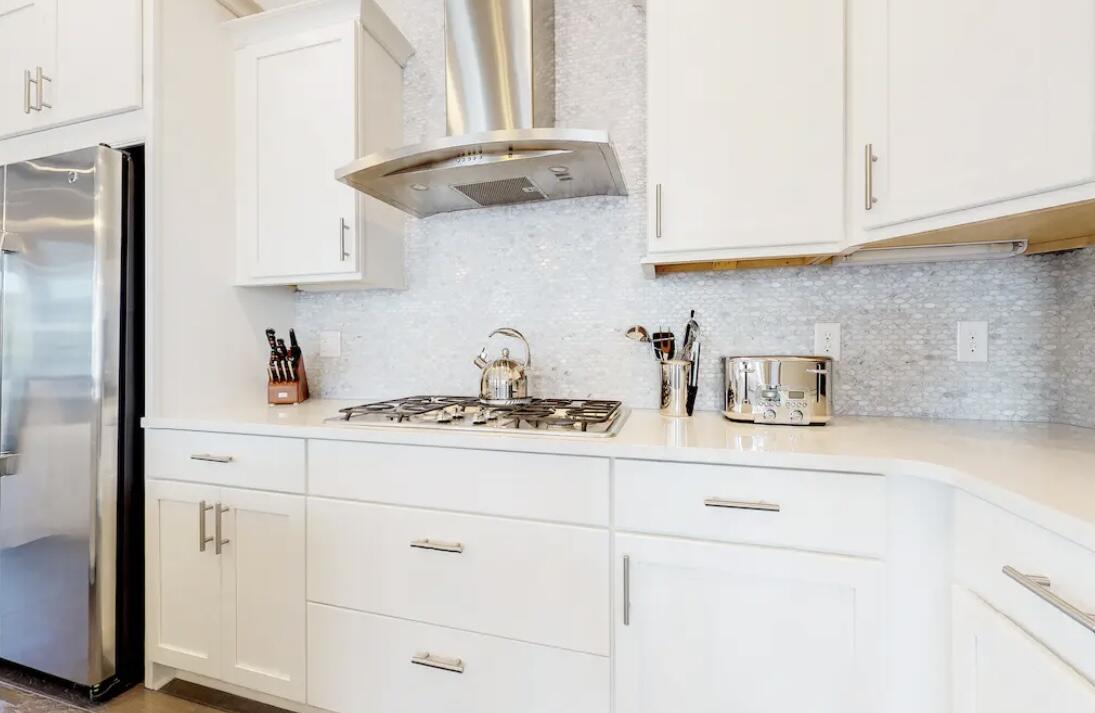 106 York Ln Inlet Beach, Unit A Inlet Beach, FL 32461 - Photo 6 of 28 a kitchen with stainless steel appliances granite countertop white cabinets and a sink