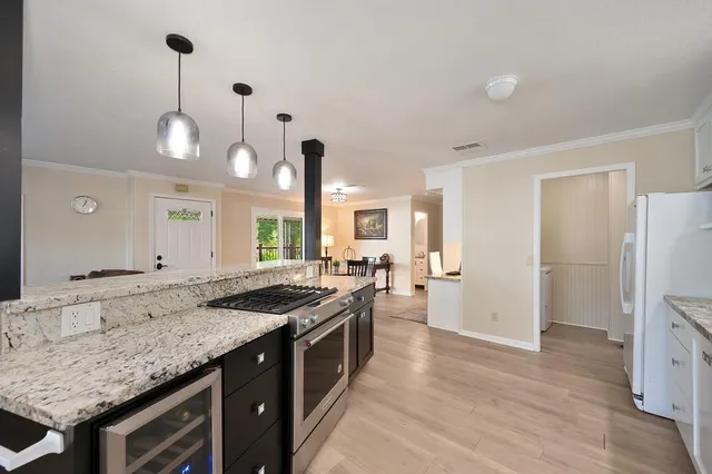 a kitchen with stainless steel appliances granite countertop a sink stove and refrigerator