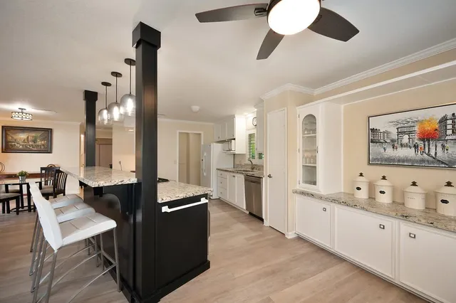 a living room with furniture a flat screen tv and a window