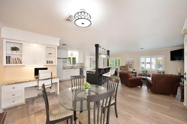 a view of a dining room with furniture window and wooden floor