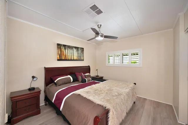 a bedroom with a bed window and a dresser