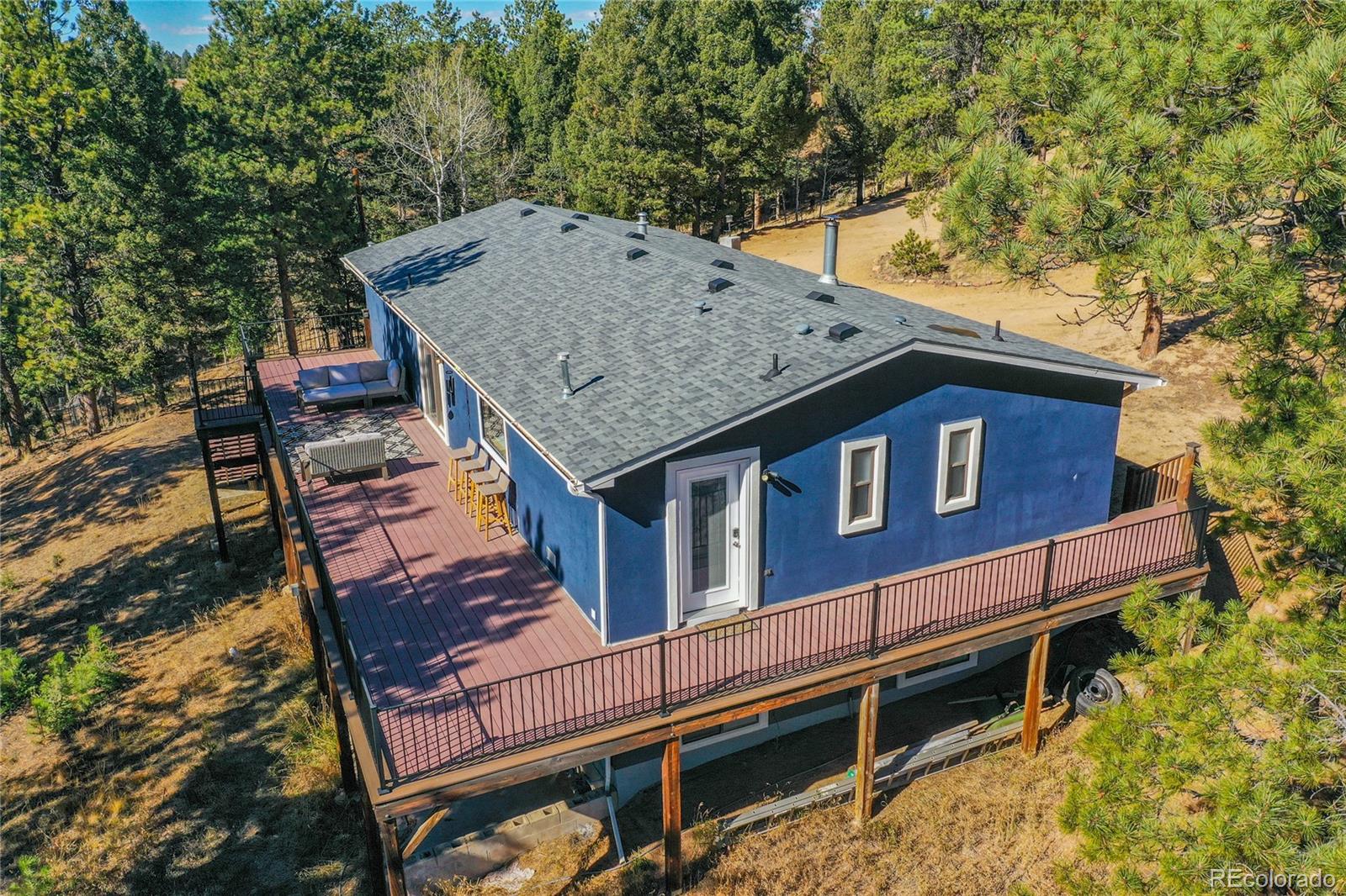 944 County Road 512 Divide, CO 80814 - Photo 15 of 49 a roof view of a house with a yard