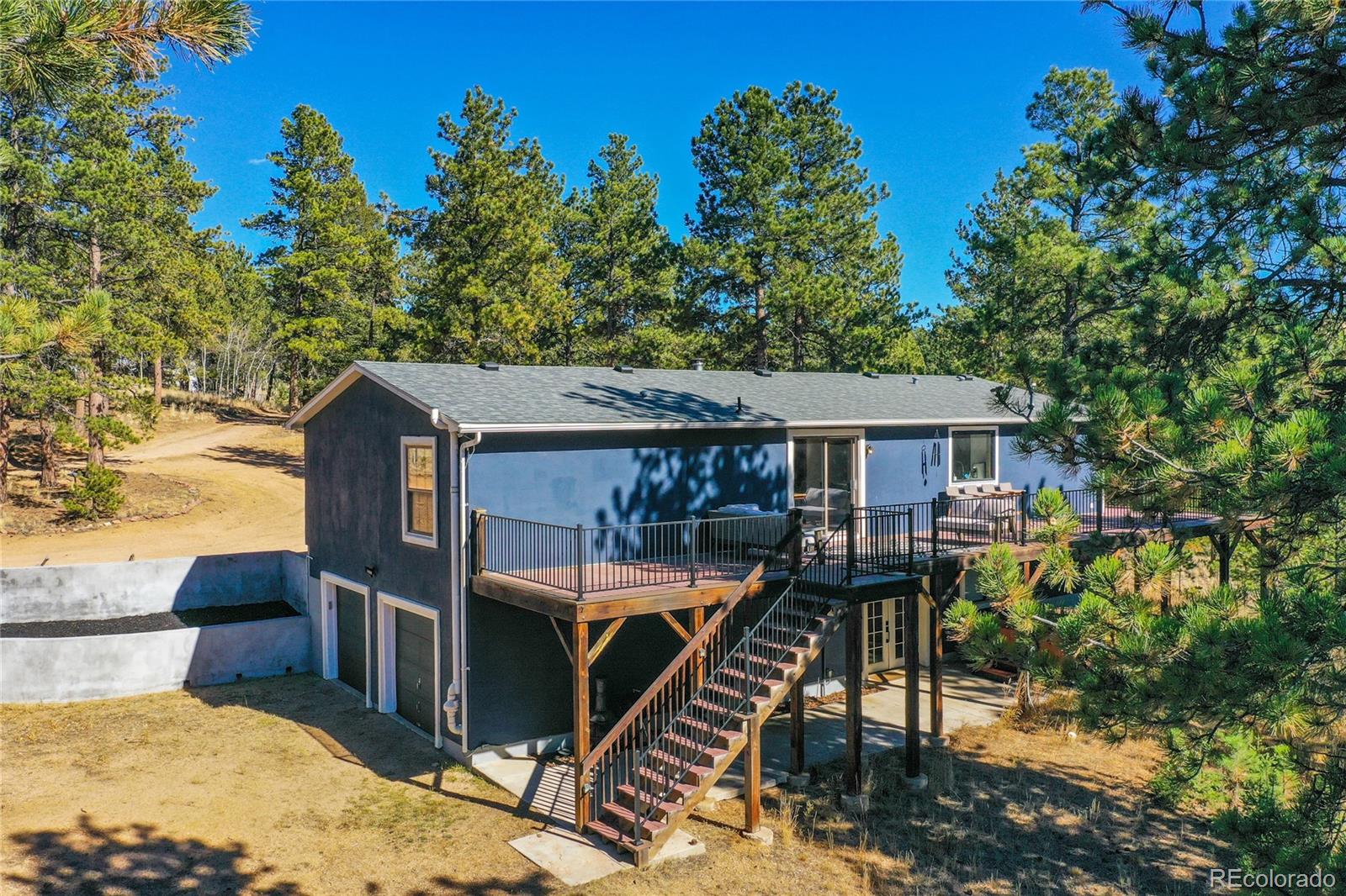 944 County Road 512 Divide, CO 80814 - Photo 2 of 49 a view of a house with backyard and sitting area