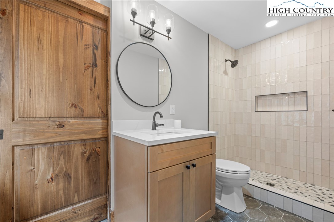 1904 Highway 194 Boone, NC 28607 - Photo 13 of 29 a bathroom with a toilet a sink and a mirror