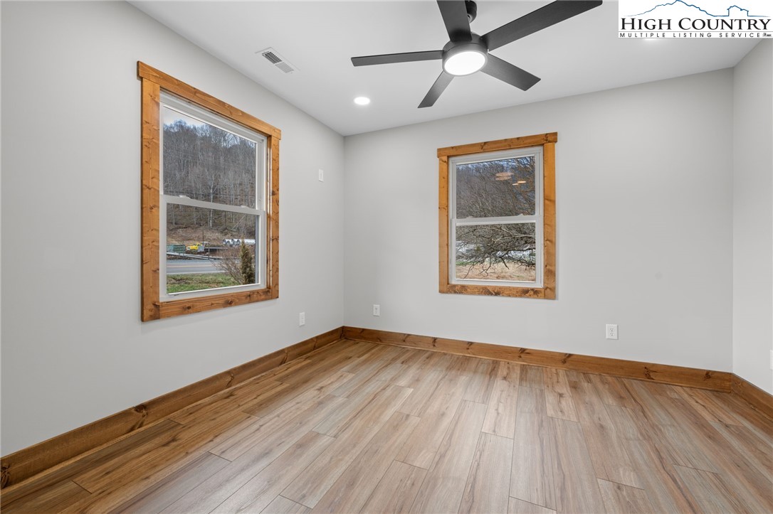1904 Highway 194 Boone, NC 28607 - Photo 14 of 29 a view of an empty room with wooden floor and a window