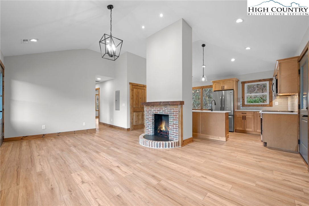 1904 Highway 194 Boone, NC 28607 - Photo 5 of 29 a view of a room with wooden floor fireplace and windows