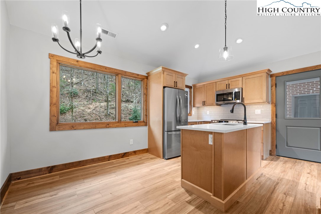 1904 Highway 194 Boone, NC 28607 - Photo 7 of 29 a kitchen with stainless steel appliances granite countertop a refrigerator a stove top oven a sink and dishwasher