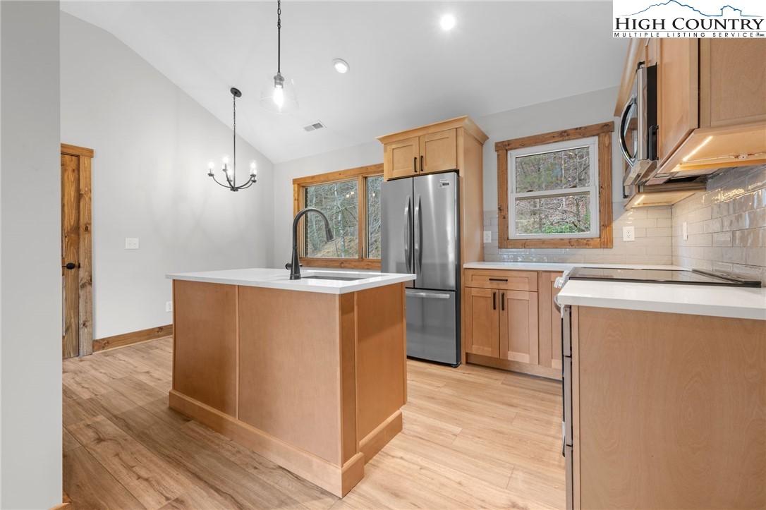1904 Highway 194 Boone, NC 28607 - Photo 8 of 29 a kitchen with sink a refrigerator and a stove