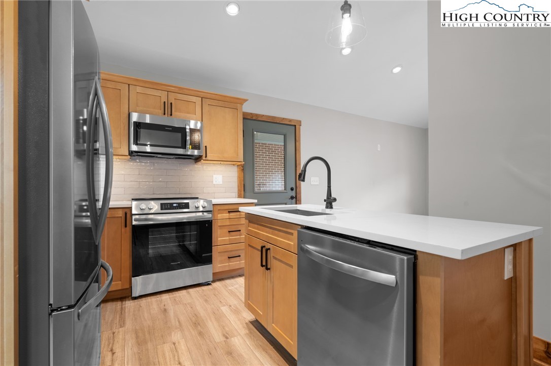 1904 Highway 194 Boone, NC 28607 - Photo 9 of 29 a kitchen with stainless steel appliances a sink stove and refrigerator