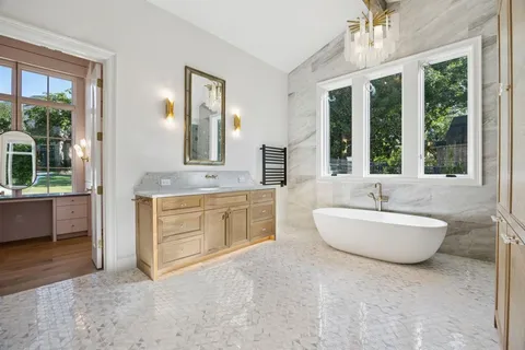a spacious bathroom with a granite countertop sink and a mirror
