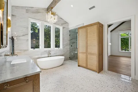 a spacious bathroom with a sink a mirror and a shower