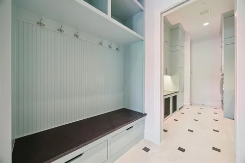 an empty room with windows fireplace and wooden floor