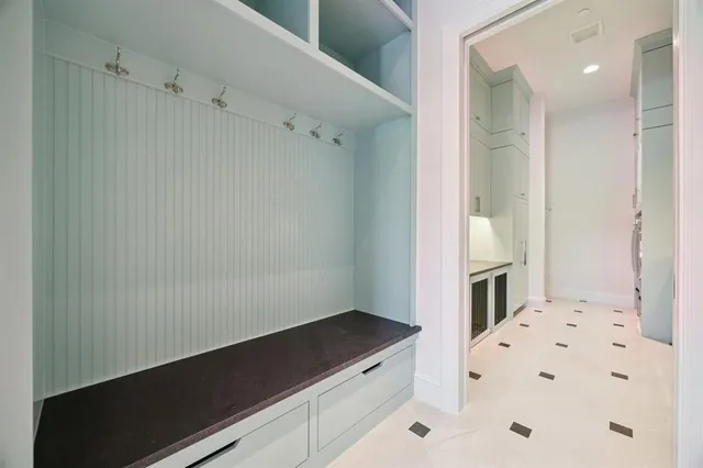 an empty room with windows fireplace and wooden floor