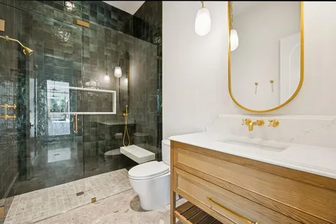 a view of staircase with lots of frames on wall and a window