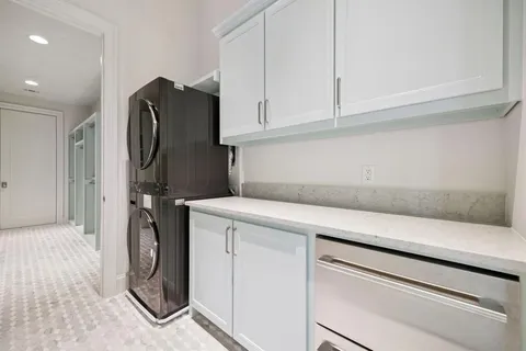 a bathroom with a granite countertop sink a toilet and a large mirror