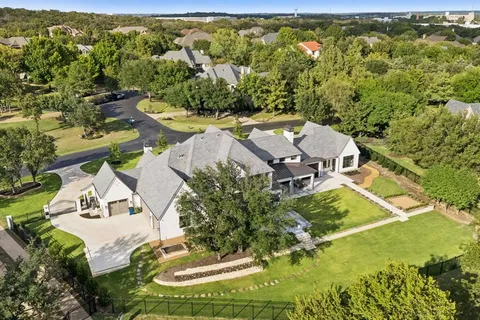 a view of a swimming pool with lawn chairs and couches