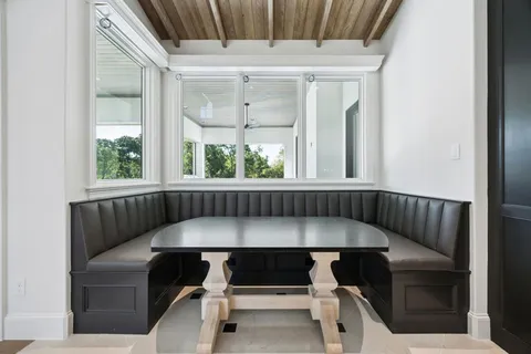 a balcony with table and chairs