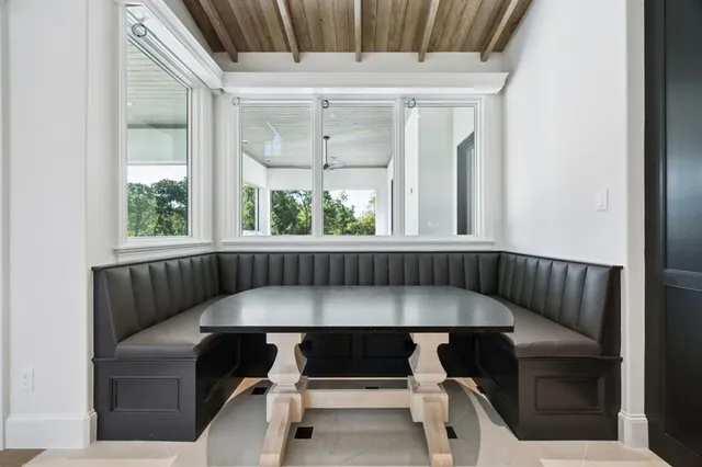 a balcony with table and chairs