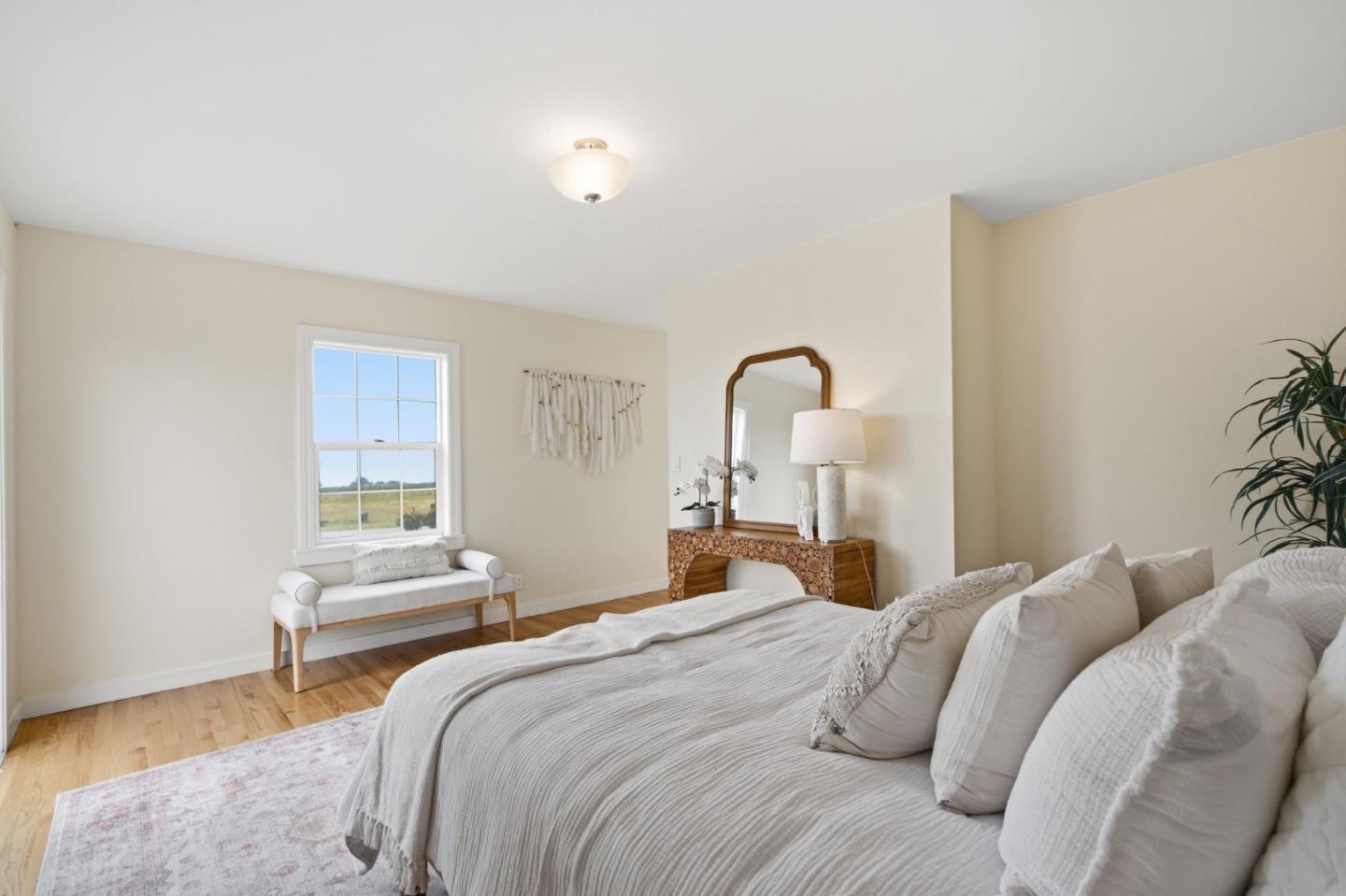 1263 Reservoir Road Pescadero, CA 94060 - Photo 36 of 66 a bedroom with a bed and a potted plant