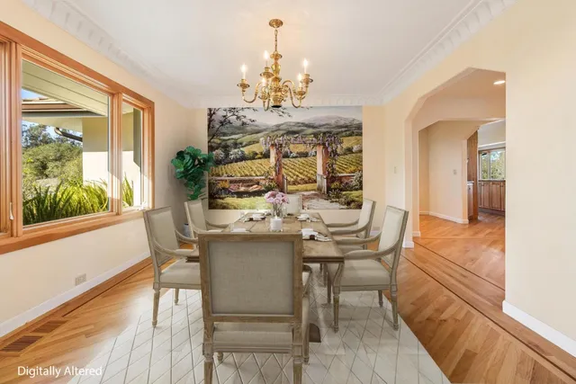 a view of a dining room with furniture a chandelier and wooden floor