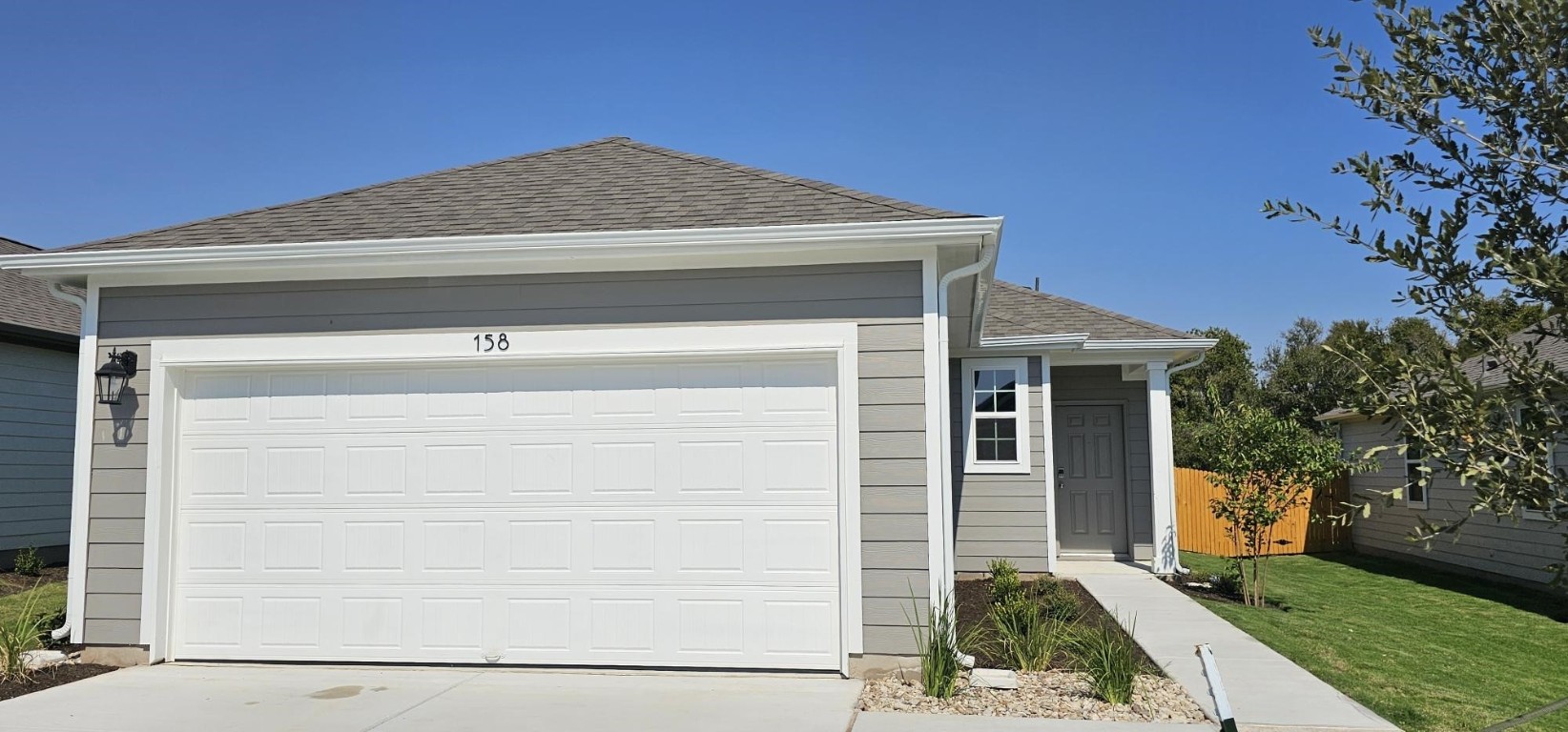 a front view of a house with garage