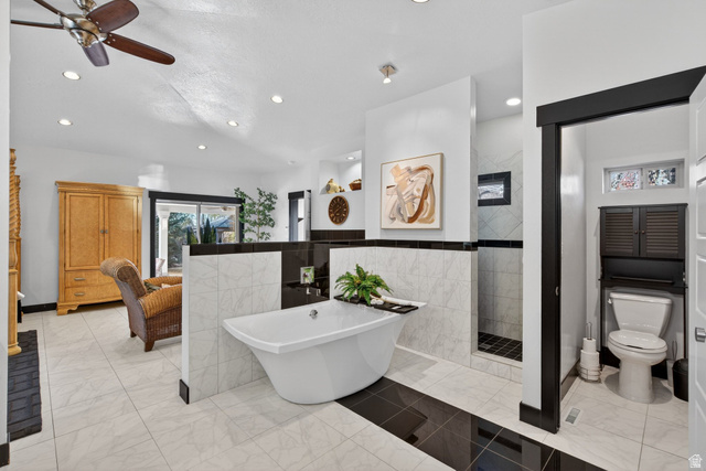 145 Carnesecca Court Mapleton, UT 84664 - Photo 57 of 109 Full bathroom with a tile shower, a soaking tub, a ceiling fan, ensuite bathroom, and light marble finish flooring