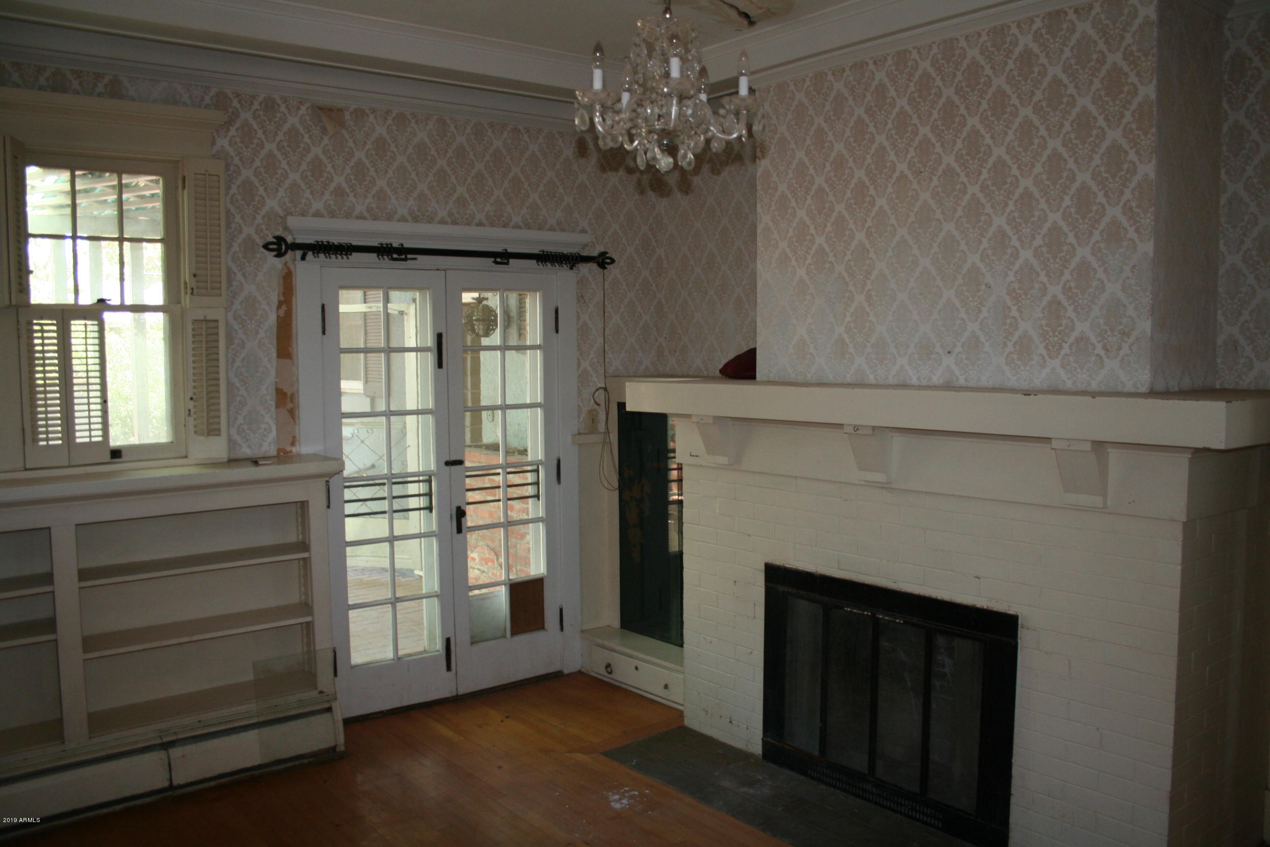 200 E Vista Bisbee, AZ 85603 - Photo 14 of 96 a view of an empty room with a fireplace and a window