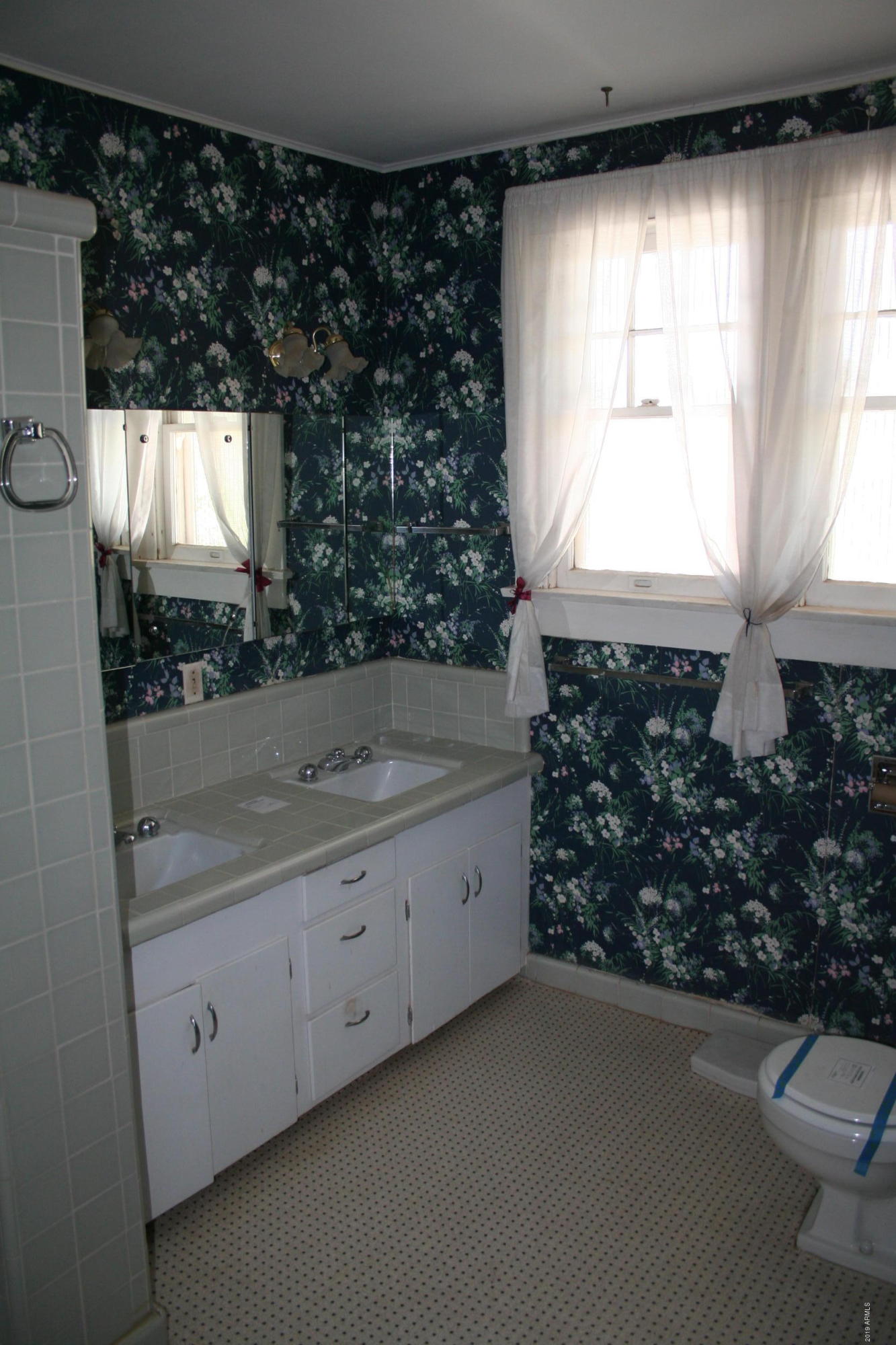 200 E Vista Bisbee, AZ 85603 - Photo 22 of 96 a bathroom with a toilet sink and mirror