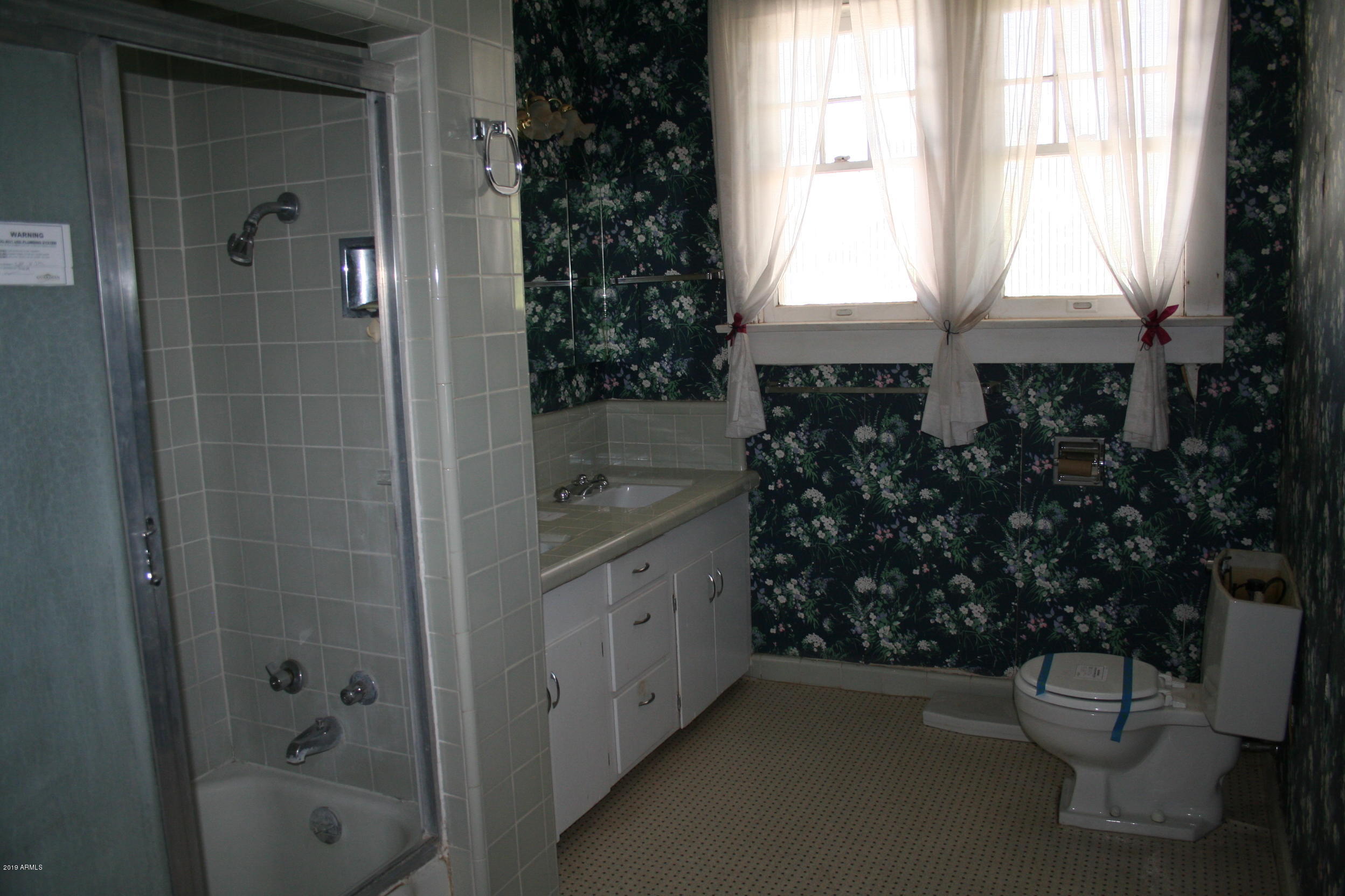 200 E Vista Bisbee, AZ 85603 - Photo 25 of 96 a bathroom with a toilet a sink and shower