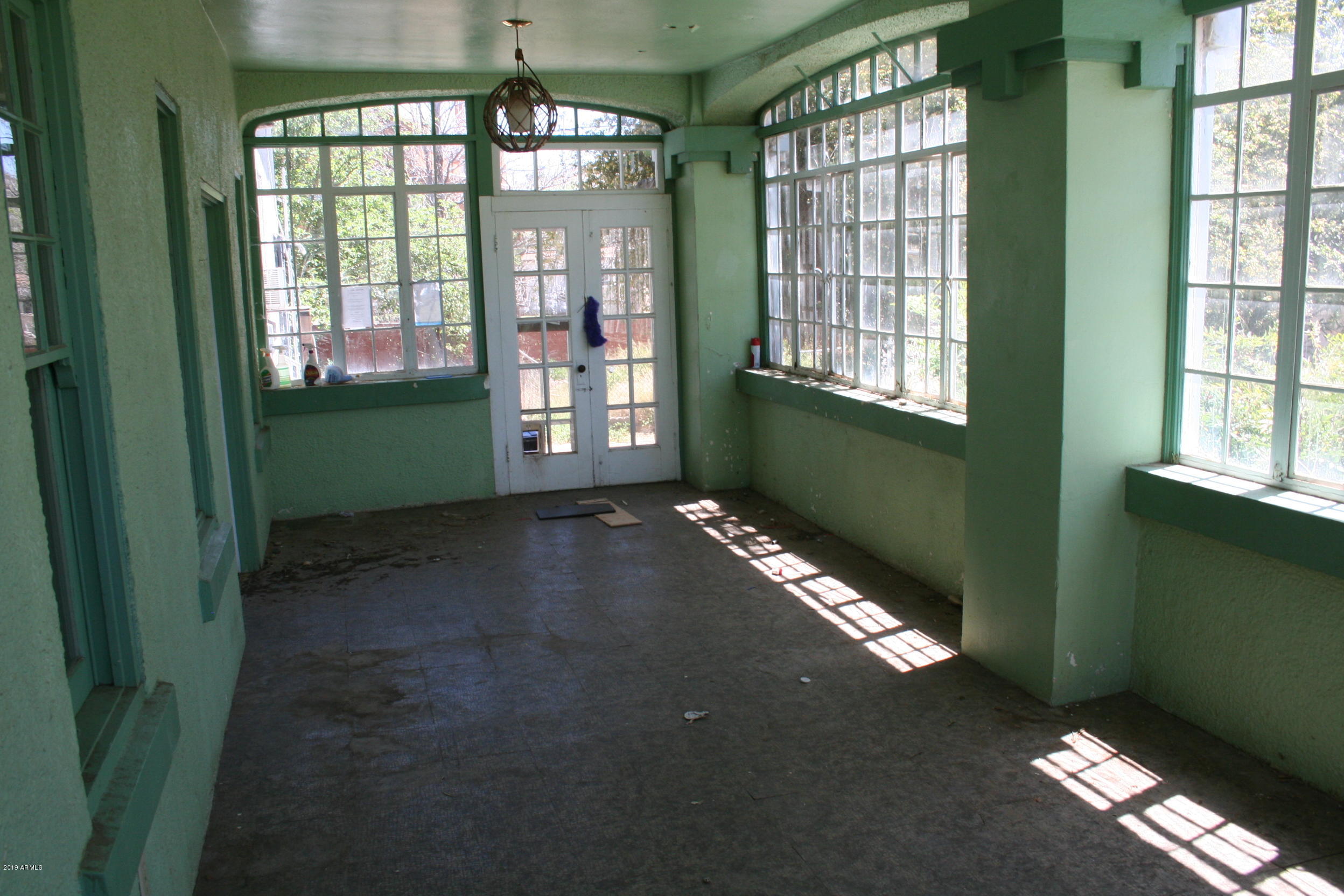 200 E Vista Bisbee, AZ 85603 - Photo 81 of 96 a view of an empty room with window and chandelier