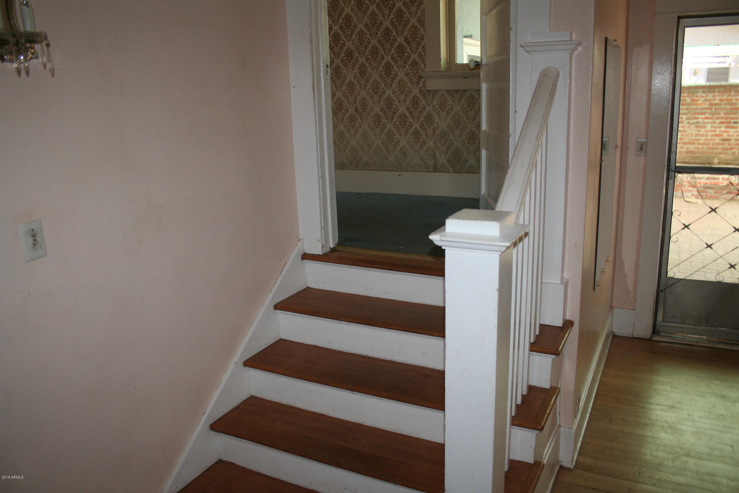 200 E Vista Bisbee, AZ 85603 - Photo 84 of 96 a view of entryway with wooden floor and staircase