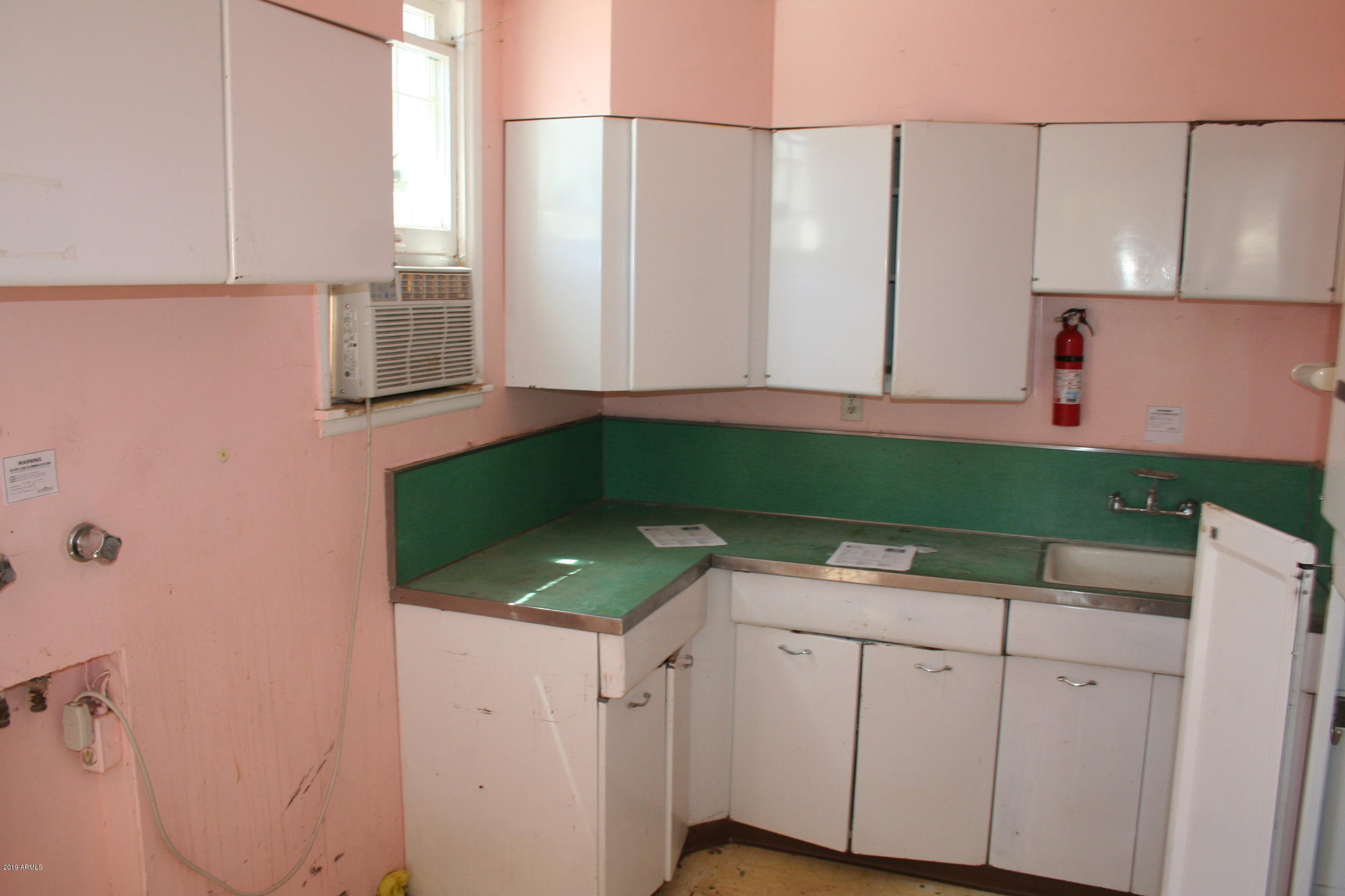 200 E Vista Bisbee, AZ 85603 - Photo 10 of 96 a kitchen with a sink and cabinets