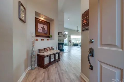 a large kitchen with stainless steel appliances kitchen island granite countertop a refrigerator and a stove top oven