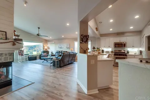 a large kitchen with stainless steel appliances lots of counter space and a sink