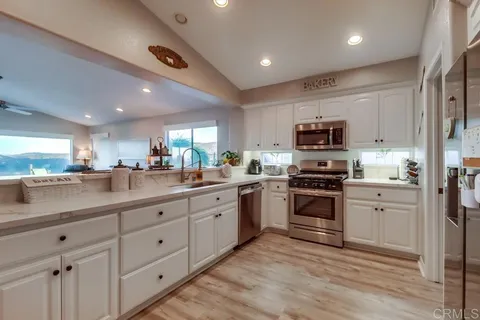 a view of a storage and utility room with washer and dryer
