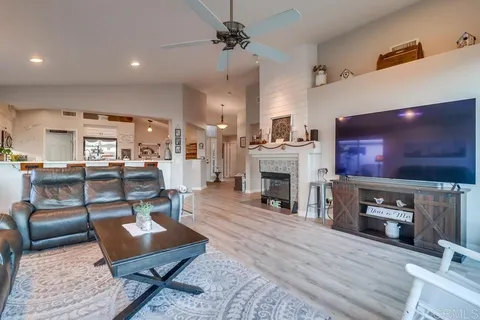 a bedroom with a bed a mirror and lamp