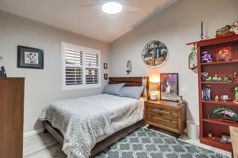 a bedroom with a bed and a desk