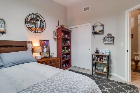 a bedroom with a bed and a chair in it