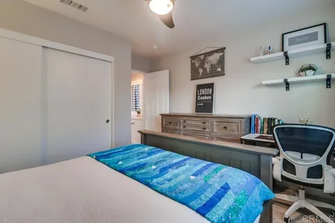 a view of a pathway of a house with potted plants