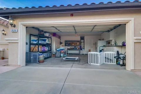 a view of a patio with a table and chairs under an umbrella